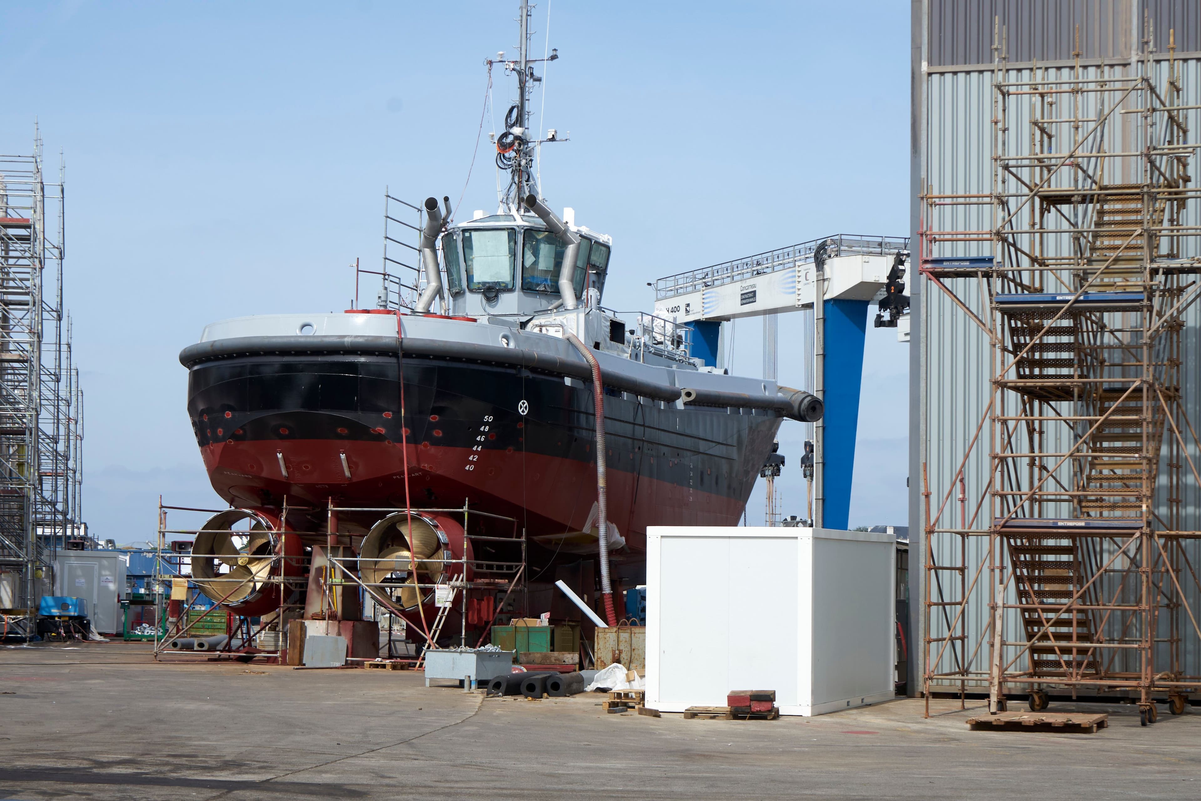 Heavy-lift unit suspended from a crane alongside the vessel