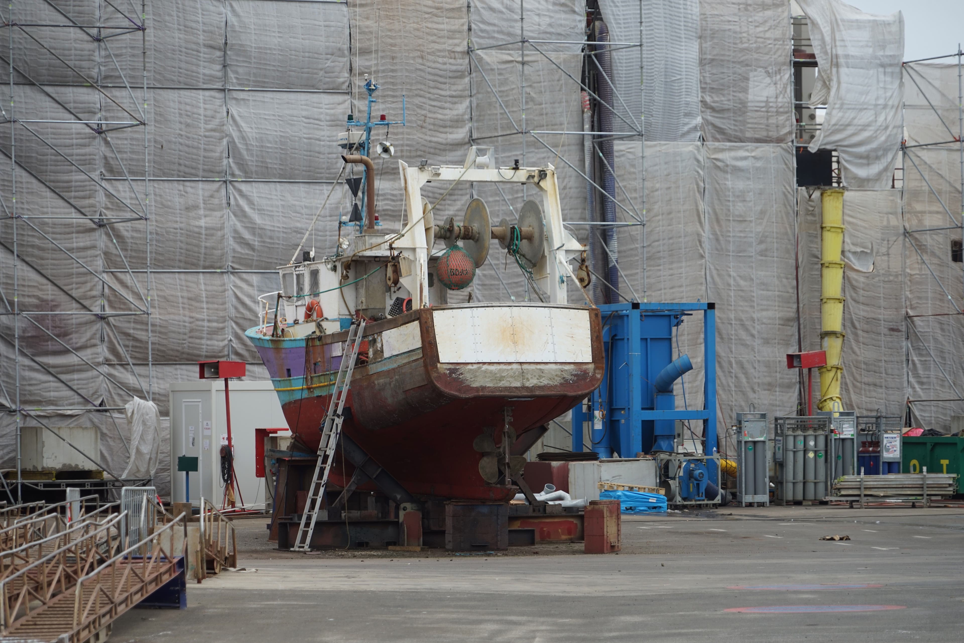 Wrapped machinery packages secured in the vessel hold